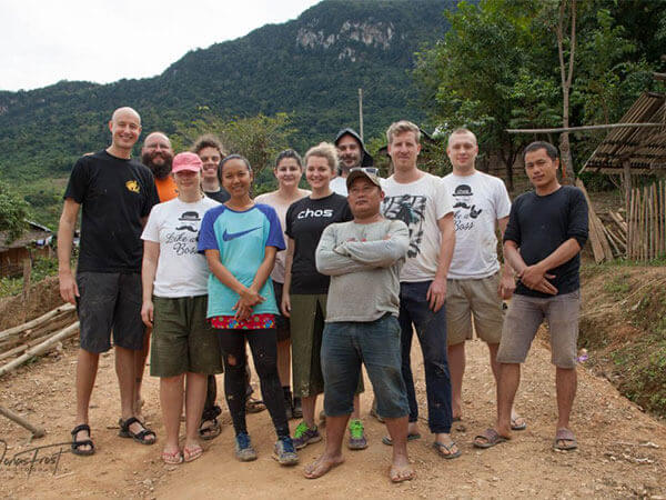 Visitors and locals posing for picture in rural village